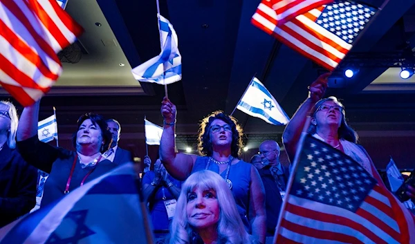 A crowd waves U.S. and Israeli flags during the Christians United For Israel event  July 17, 2023 (AP)