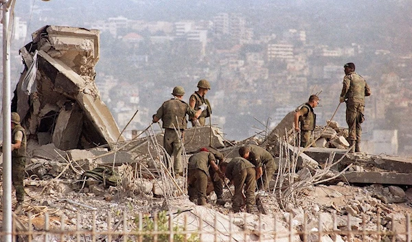 US troops scrummaging around the destroyed US Marine Base in Beirut, October 23 1983 (AP)