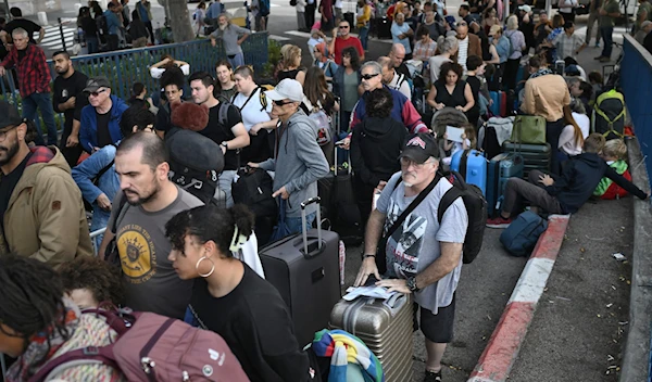 US-Israeli settlers wait to be evacuated from the port of Haifa to Cyprus, on October 16, 2023. (AFP)