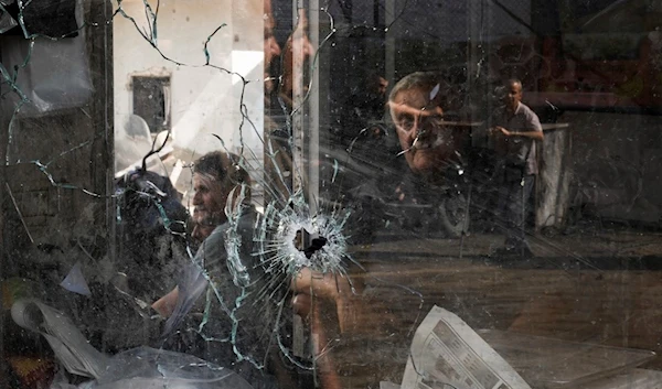 A bullet hole is seen in a shop window following an Israeli Occupation Forces raid in the Jenin refugee camp, West Bank, Occupied Palestine, Wednesday, Sept. 20, 2023. (AP)