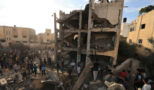 Palestinians search through the rubble of a building after an Israeli strike in Khan Younis in the southern Gaza Strip, Palestine, Oct. 17, 2023. (AFP)