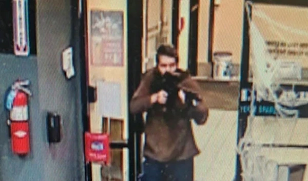 In this image taken from video released by the Androscoggin County Sheriff's Office, an unidentified shooter points a gun while entering Sparetime Recreation in Lewiston, Maine, on Wednesday, Oct. 25, 2023. (AP)