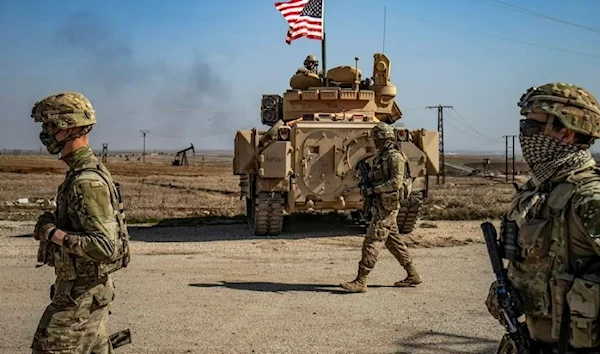 US occupation soldiers walk while on patrol by the Suwaydiyah oil fields in Syria's northeastern al-Hasakah province on February 13, 2021. (AFP)