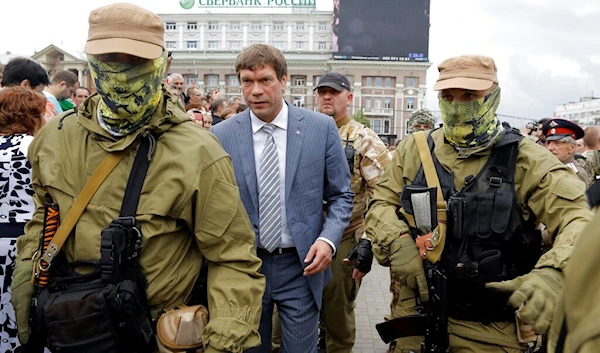 Former Ukrainian lawmaker Oleg Tsarev, walks accompanied by Donetsk security, Donbass region, Saturday, June 21, 2014. (AP)