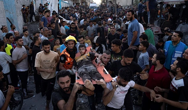 Palestinians carry an injured person on a stretcher after an Israeli Occupation airstrike in Khan Younis, Gaza Strip, Occupied Palestine Saturday, Oct. 21, 2023. (AP)