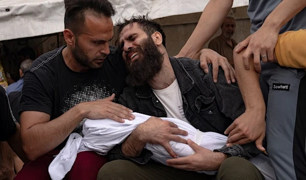 Palestinians mourn their relatives killed in the Israeli bombardment of the Gaza Strip, in a morgue in Khan Younis, occupied Palestine, Sunday, Oct. 29, 2023. ( AP)