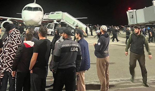 People in the crowd walk at an airfield of the airport in Makhachkala, Dagestan, Russia, Oct. 30, 2023