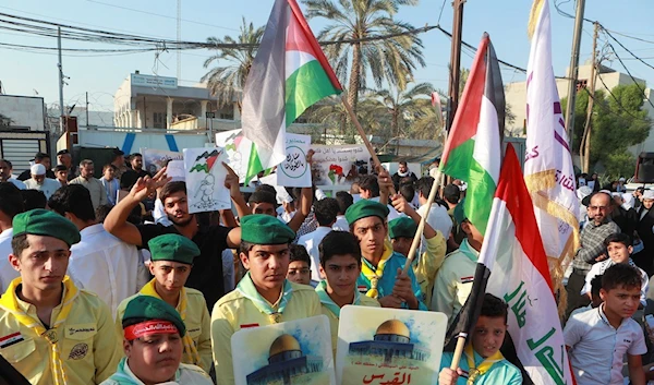 Iraqi children hold Palestinian flags during a demonstration in solidarity with the Gaza Strip, in Basra, Iraq, Friday, Oct. 27, 2023 (AP Photo/Nabil al-Jurani)