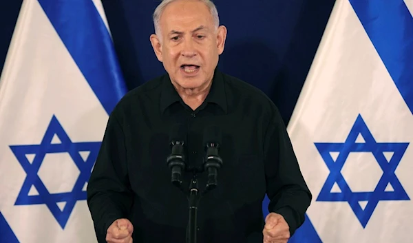 Israeli Prime Minister Benjamin Netanyahu speaks during a press conference with Defense Minister Yoav Gallant and Cabinet Minister Benny Gantz in the Kirya military base in "Tel Aviv", Occupied Palestine, Saturday, Oct. 28, 2023 (AP)