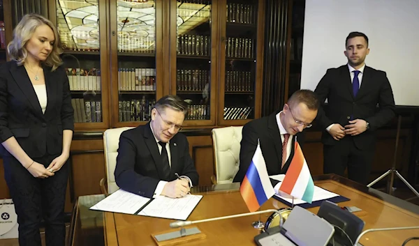 Hungarian FM Peter Szijjarto and Director General of Rosatom Alexey Likachev in April 2023 in Moscow signing an agreement (AP)