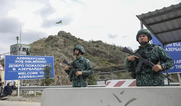 Azerbaijani servicemen guard the Lachin checkpoint on the in Azerbaijan, Sunday, Oct. 1, 2023 (AP)