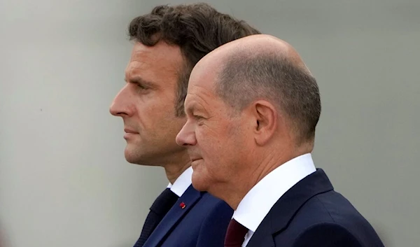 German Chancellor Olaf Scholz, right, welcomes French president Emmanuel Macron prior to a meeting at the chancellery in Berlin, Germany, Monday, May 9, 2022. (AP)