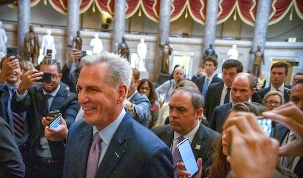 Speaker of the House Kevin McCarthy, R-Calif., is surrounded by police and press on the way to the chamber, at the Capitol in Washington, Tuesday, Oct. 3, 2023. (AP)