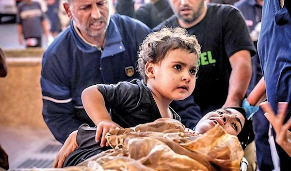 A wounded Palestinian woman and her child are wheeled into hospital in Khan Yunis in the southern Gaza Strip on Oct 26, 2023 (AFP)