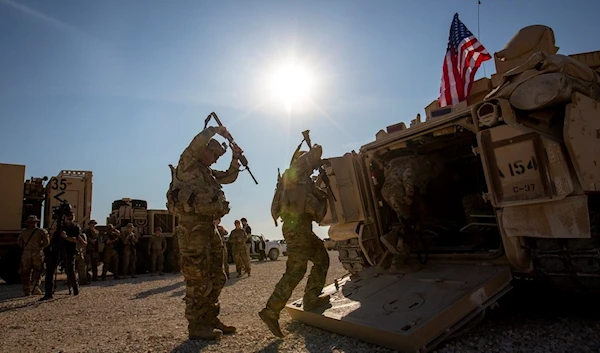 Crewmen enter Bradley fighting vehicles at a US military base at an undisclosed location in Northeastern Syria, on November 11, 2019  (AP)