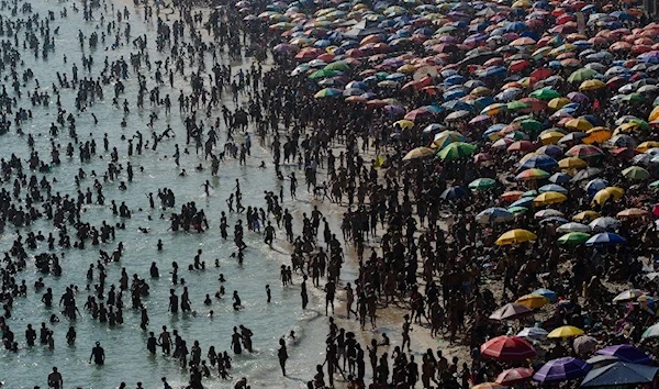 Sunbathers enjoy Macumba beach, in Rio de Janeiro, on September 24, 2023, during a heat wave (AFP)