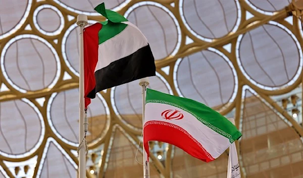 The flags of United Arab Emirates and Iran are pictured during a national event at the Iranian Pavilion of Expo 2020, in the Gulf emirate of Dubai on February 7, 2022. (AFP)