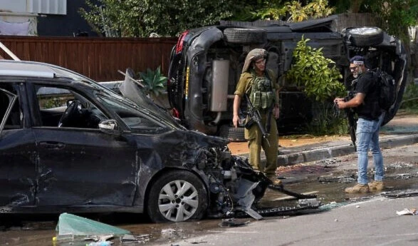 Israeli settler and a soldier in “Sderot”, “Israel”, Sunday, Oct.8, 2023. (AP)