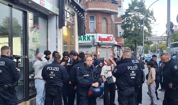 German Police, on Sonnenallee, often referred to as the "Arab Street", stopping and questioning every person walking while wearing a kuffiyeh. (Twitter)