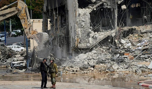 An Israeli digger removes the rubble from ‘Sderot’, Oct.8, 2023. (AP)