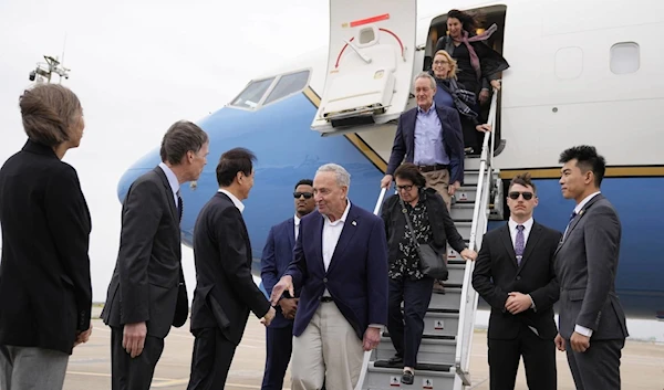 US Senate Majority Leader Chuck Schumer, D-N.Y., center, and other members of the delegation arrive at Shanghai Pudong International Airport in Shanghai, China, Saturday, Oct. 7, 2023. (AP)