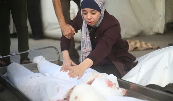 A Palestinian woman mourns children killed in the Israeli bombardment of the Gaza Strip in Rafah on Saturday, Oct. 21, 2023 (AP)