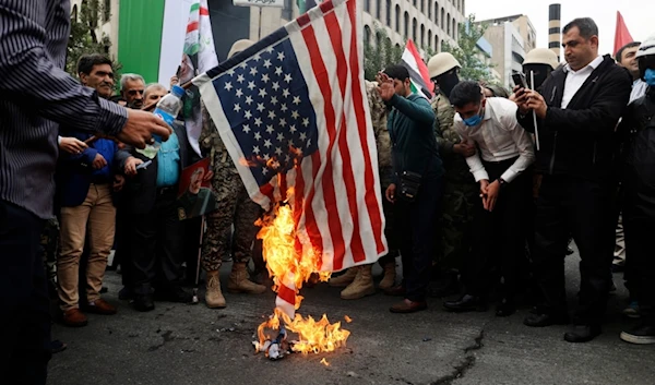 Iranian worshippers burn a U.S. flag during their pro-Palestinian rally before the Friday prayers in Tehran, Iran, Friday, Oct. 13, 2023. (AP Photo)