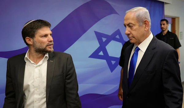 Israeli Prime Minister Benjamin Netanyahu, right, talks with Finance Minister Bezalel Smotrich, left, during the weekly cabinet meeting in the prime minister's office in Al-Quds, June 25, 2023.(AP)