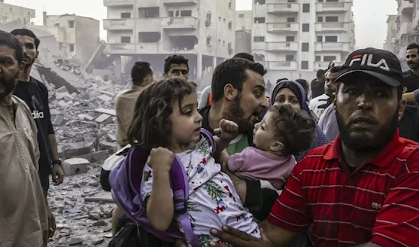 Families including children are forcibly displaced after Israeli air strike in the south destroyed a doctor's house, wiping out the entire family on October 15 (AFP)