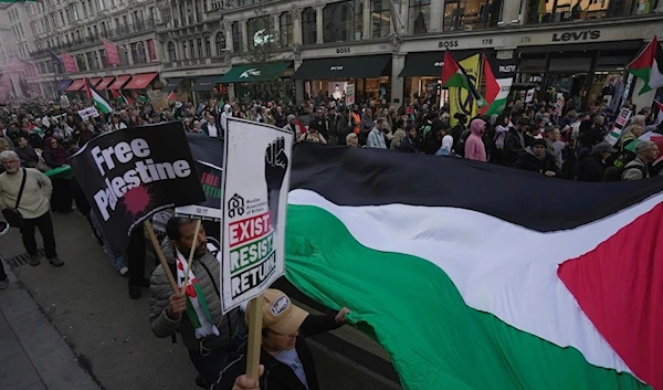 Protesters attend a pro-Palestinian demonstration in London, England, October 14, 2023 (AP)