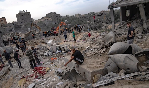 Palestinians look for survivors following an Israeli airstrike in Khan Younis, southern Gaza Strip, Sunday, Nov. 12, 2023 ( AP Photo/Fatima Shbair)