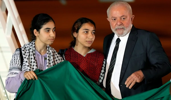 Brazil's President Luiz Inacio Lula da Silva talks to two young Brazilian women who were in the Gaza Strip, during their arrival at the Air Base, in Brasilia, Brazil, Monday, Nov. 13, 2023. (AP)