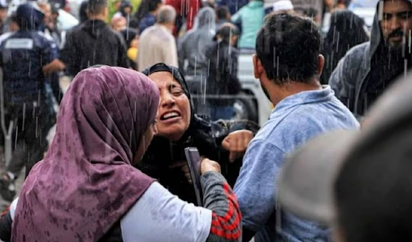 A Palestinian woman mourns for her family members killed by Israeli bombardment ahead of a mass funeral outside Nasser Hospital in Khan Younis. (AFP)