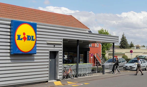 People walk into a Lidl supermarket in Chambourcy, 30 km west of Paris, Thursday, June 16, 2011. (AP)