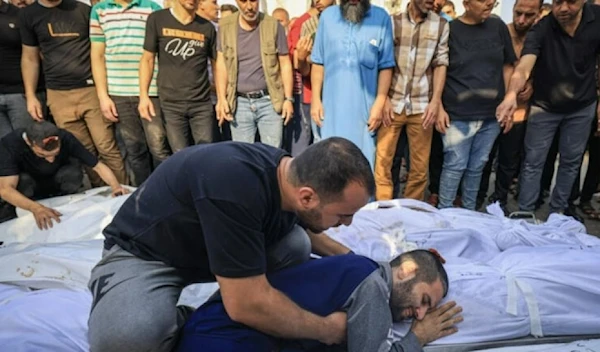 A Palestinian man mourns the loss of a family member following a strike in the southern town of Khan Yunis (AFP)