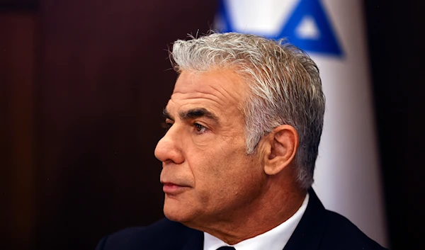 Israeli Prime Minister Yair Lapid chairs the weekly cabinet meeting, in occupied al-Quds, Sunday, Sept. 11, 2022. (AP)