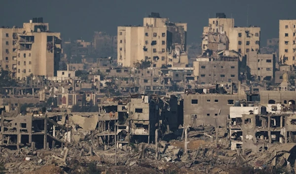 Destroyed buildings stand in the Gaza Strip, as seen from southern occupied Palestine, Thursday, Nov. 16, 2023 (AP Photo)