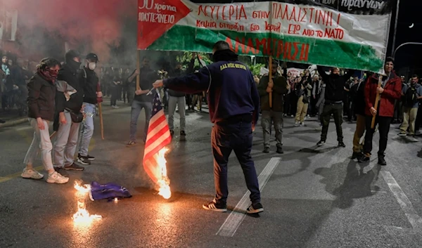 Pro- Palestinian protesters burn a U.S. flag out of the U.S. embassy in Athens, Friday, Nov. 17, 2023. (AP)