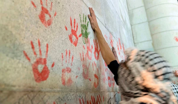 A protester make hand prints on the wall of Union Station building during a pro-Palestinian demonstration asking for a cease fire in Gaza in Washington, Friday, Nov. 17, 2023. (AP)