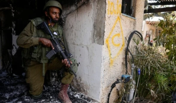 An Israeli soldier takes a position in “Kibbutz Kfar Aza” on Tuesday, Oct. 10, 2023. (AP)