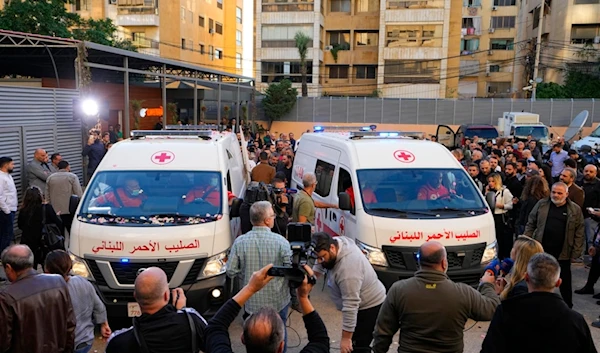 Journalists and family members gather next to Red Cross ambulances carrying the bodies of the two martyred Al Mayadeen journalists killed by an Israeli strike in southern Lebanon, at the station's headquarters in Beirut, Lebanon, Nov. 21, 2023