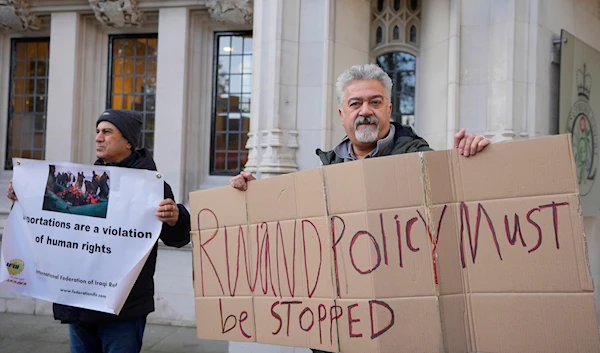 Protesters stand outside the Supreme Court in London, Wednesday, Nov. 15, 2023. (AP)