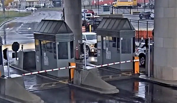 In this photo taken from security video, a light colored vehicle, top left, travels toward the Rainbow Bridge customs plaza, Nov. 22, 2023, in Niagara Falls, New York (AP)