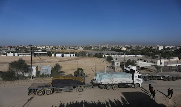 Trucks carrying humanitarian aid enter Gaza Strip from Egypt in Rafah as a temporary ceasefire went into effect Friday, Nov. 24, 2023 (AP Photo/Hatem Ali)