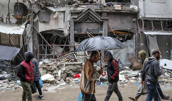 Palestinians walk in Gaza City on Monday, Nov. 27, 2023 (AP)