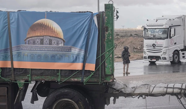 Trucks carrying humanitarian aid line up to cross Rafah crossing port on their way to Gaza Strip, in Rafah, Egypt, Monday, Nov. 27, 2023. (AP)