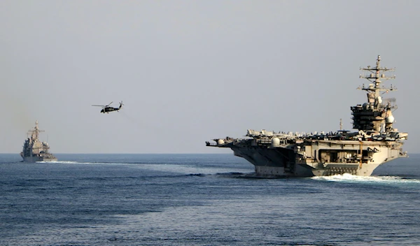 The aircraft carrier USS Dwight D. Eisenhower and other warships crosses the Strait of Hormuz into the Persian Gulf on Sunday, Nov. 26, 2023 (AP)