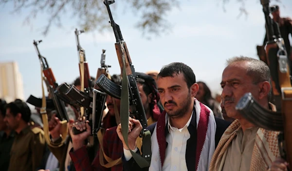 Armed Ansar Allah fighters attend the funeral procession of Yemeni Armed Forces fighters who were killed in recent fighting with Saudi-backed forces, in Sanaa, Yemen, November 24, 2021 (AP)