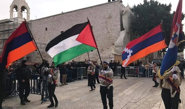 Armenian scouts in occuppied Al-Quds wave the flags of Armenia, Palestine, and the dissolved autonomous republic of Artsakh (Nagorno-Karabakh),   Dec 24, 2017 (social media)