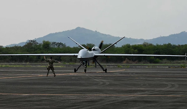 A US soldier guides the MQ-9 Reaper drone as it lands at Subic Bay Freeport Zone on April 23, 2023 (AFP)